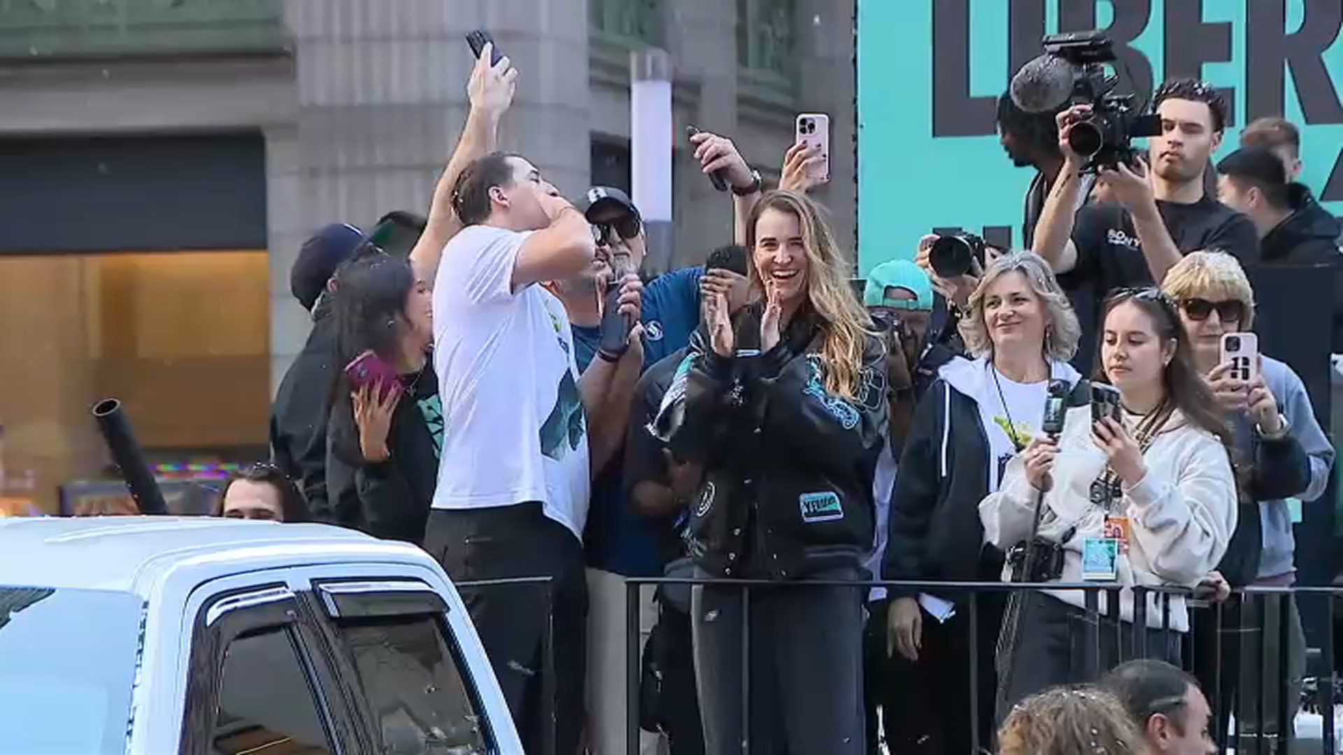 New York Liberty star player Sabrina Ionescu waves to the fans and celebrates on a parade float.