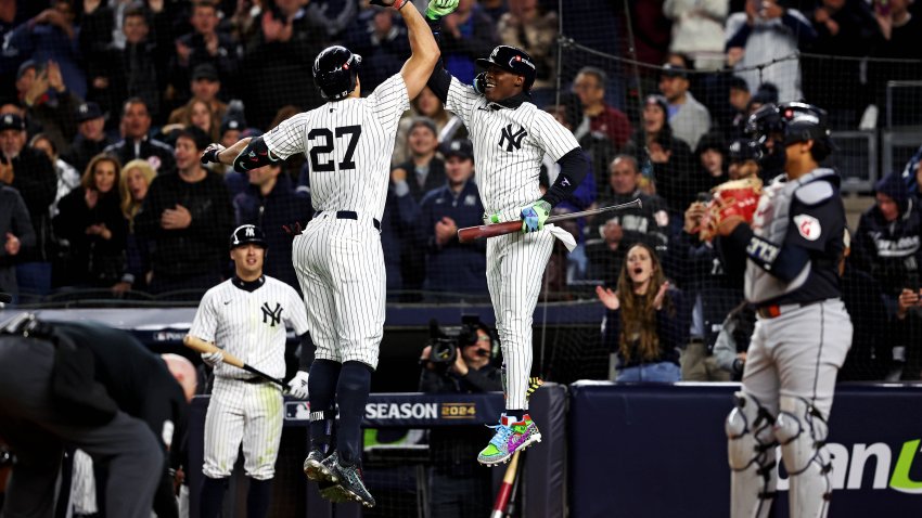 Oct 14, 2024; Bronx, New York, USA; New York Yankees designated hitter Giancarlo Stanton (27) celebrates with shortstop Anthony Volpe (11) after hitting a solo home run during the seventh inning against the Cleveland Guardians in game one of the ALCS for the 2024 MLB Playoffs at Yankee Stadium. Mandatory Credit: Wendell Cruz-Imagn Images