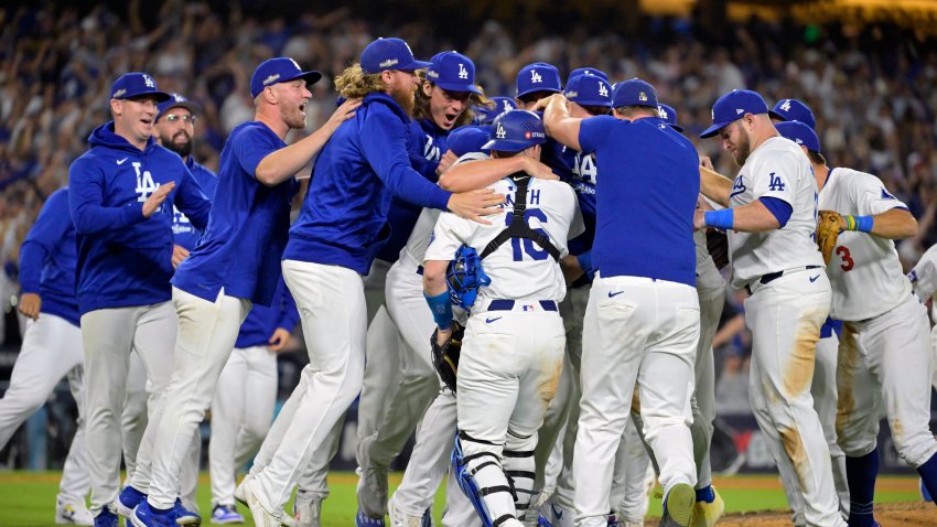 Oct 20, 2024; Los Angeles, California, USA; Los Angeles Dodgers pitcher Blake Treinen (49) players celebrate after defeating the New York Mets in game six of the NLCS for the 2024 MLB playoffs at Dodger Stadium. Mandatory Credit: Jayne Kamin-Oncea-Imagn Images