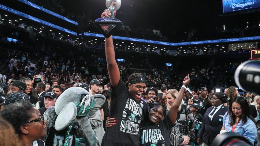 Oct 20, 2024; Brooklyn, New York, USA; New York Liberty forward Jonquel Jones (35) holds up the MVP trophy after defeating the Minnesota Lynx in overtime to win the 2024 WNBA Finals at Barclays Center. Mandatory Credit: Wendell Cruz-Imagn Images