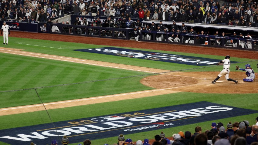 Oct 28, 2024; New York, New York, USA; New York Yankees designated hitter Giancarlo Stanton (27) singles during the sixth inning against the Los Angeles Dodgers in game three of the 2024 MLB World Series at Yankee Stadium. Mandatory Credit: Vincent Carchietta-Imagn Images