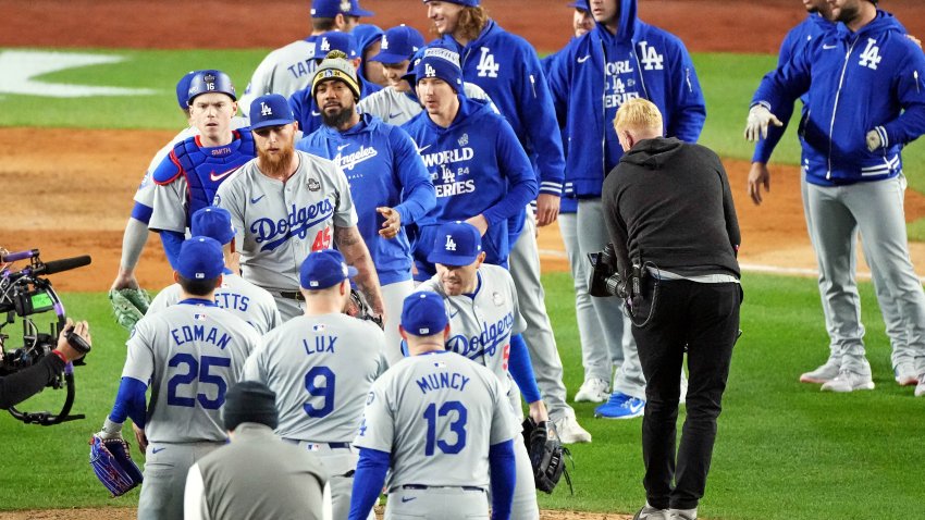 Oct 28, 2024; New York, New York, USA; The Los Angeles Dodgers celebrate with pitcher Michael Kopech (45) after defeating the New York Yankees in game three of the 2024 MLB World Series at Yankee Stadium. Mandatory Credit: Robert Deutsch-Imagn Images