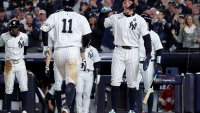 Oct 29, 2024; New York, New York, USA; New York Yankees shortstop Anthony Volpe (11) celebrates with outfielder Aaron Judge (99) after hitting a grand slam during the third inning against the Los Angeles Dodgers in game four of the 2024 MLB World Series at Yankee Stadium. Mandatory Credit: Brad Penner-Imagn Images