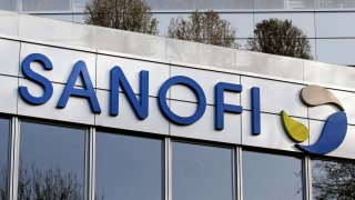 A Sanofi logo sits on the facade of the company’s headquarters on December 11, 2020 in Gentilly near Paris, France.