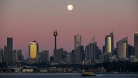 The full moon, otherwise known as a strawberry supermoon, is seen over the Skyline of the CBD in Sydney, Australia June 15, 2022.