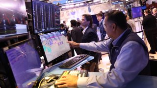 Traders work on the floor of the New York Stock Exchange during morning trading in New York City. 