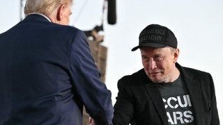 Tesla CEO Elon Musk (R) joins former U.S. President and Republican presidential candidate Donald Trump during a campaign rally at the site of his first assassination attempt in Butler, Pennsylvania, on Oct. 5, 2024.