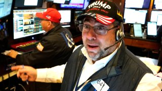 Trader Jonathan Mueller wears a Trump hat as he works on the floor of the New York Stock Exchange (NYSE) at the opening bell on November 6, 2024, in New York City.