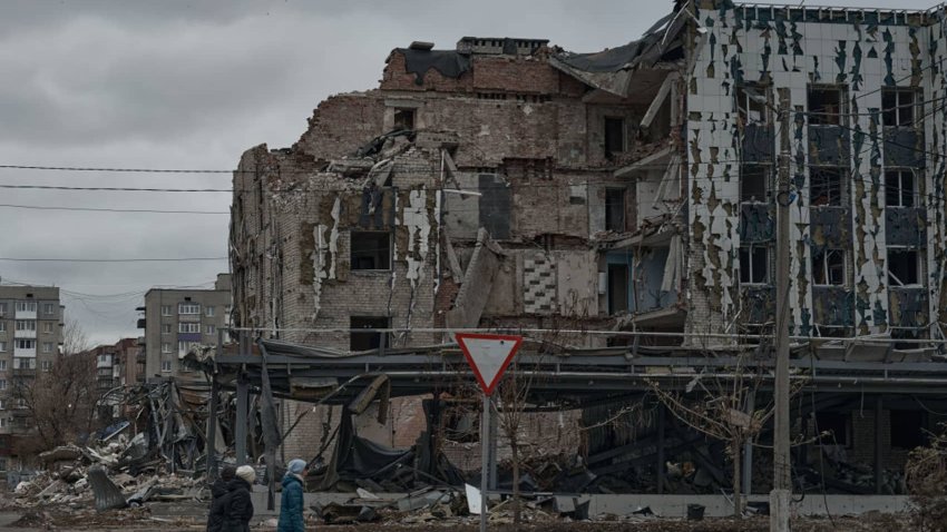 POKROVSK, UKRAINE – NOVEMBER 16:  Local residents walk past destroyed houses in the city, approximately 10 km from the frontline, on November 16, 2024 in Pokrovsk, Ukraine. (Photo by Vlada Liberova/Libkos/Getty Images)