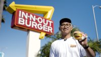 Cy Soliman holds a burger outside of In-N-Out.