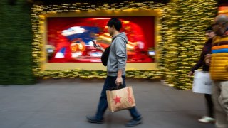 Shoppers carry their purchases on Black Friday in New York City on November 29, 2024. 