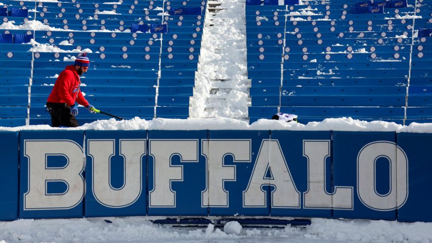 FILE - A stadium worker clears snow from seats before an NFL wild-card playoff football game between the Buffalo Bills and the Pittsburgh Steelers, Monday, Jan. 15, 2024, in Buffalo, N.Y. (AP Photo/Jeffrey T. Barnes, File)