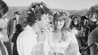 Arlo Guthrie sings “Amazing Grace” to his new bride Jackie Hyde, at their wedding ceremony on Guthrie’s Washington, Mass. farm on Oct. 9, 1969. Alice Brock of “Alice’s Restaurant” is second from the right in the background