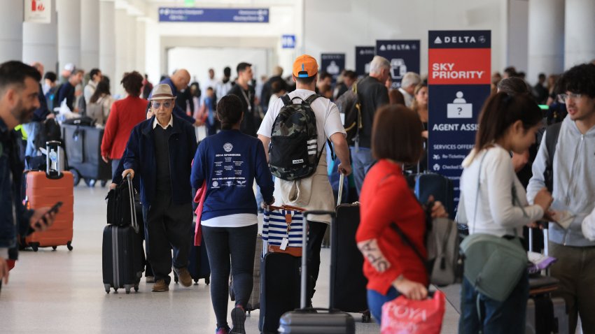 Crowds pass through a terminal at Los Angeles International Airport on November 21, 2023, in Los Angeles, as people travel ahead of the Thanksgiving holiday. (Photo by DAVID SWANSON / AFP) (Photo by DAVID SWANSON/AFP via Getty Images)