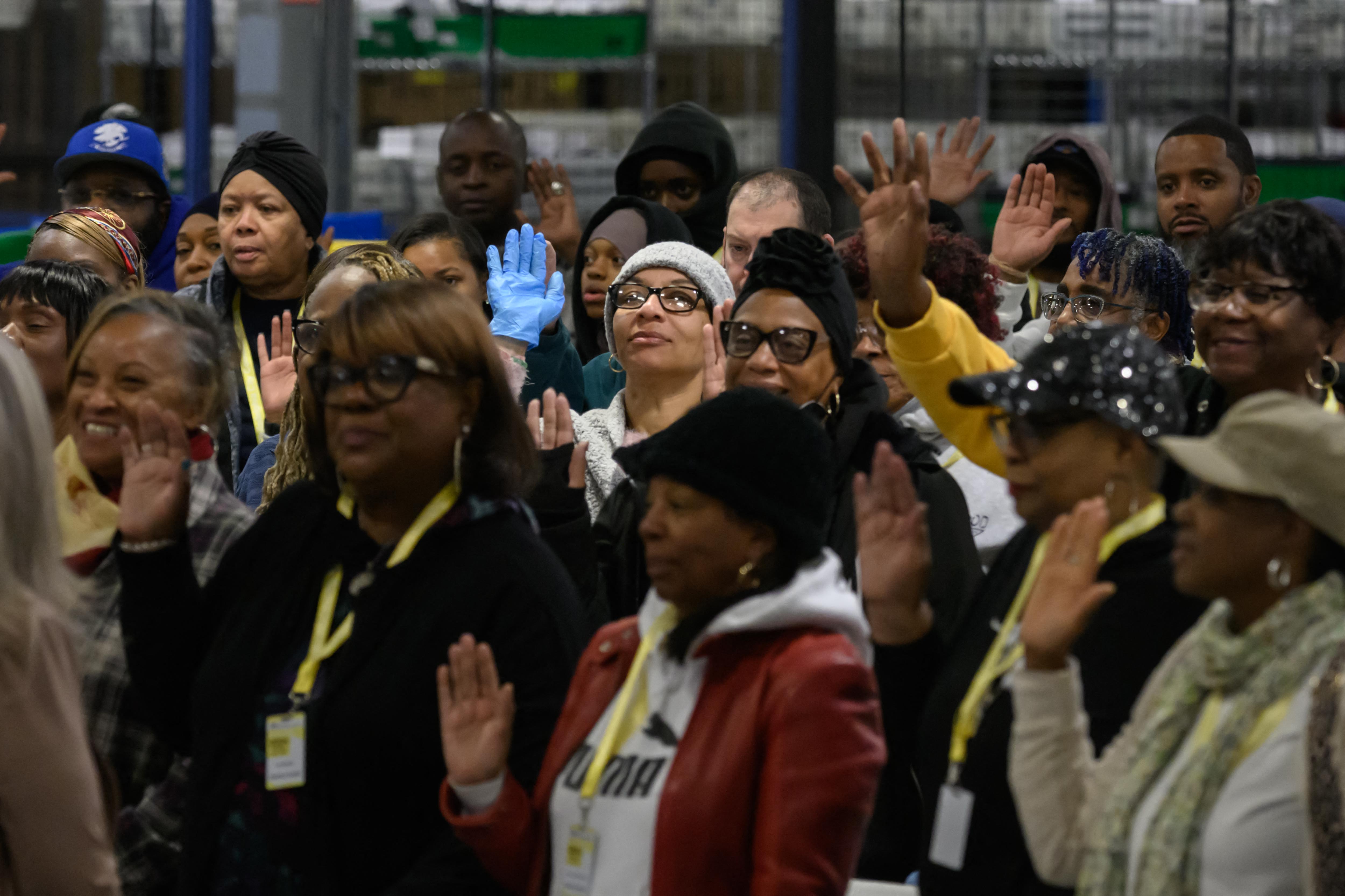 Philadelphia County board of elections staff are sworn-in before processing ballots at the ballot counting election warehouse on the outskirts of Philadelphia, Pennsylvania on November 5, 2024.