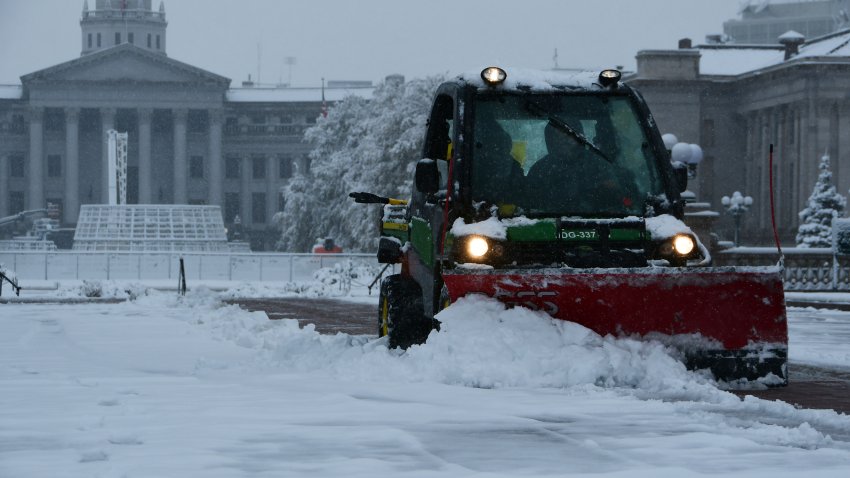 File. Driver Abner Mirander, right, and Jose Guillen of Denver Parks & Recreation sweep snows at Civic Center Park in Denver, Colorado on Wednesday, November 6, 2024.