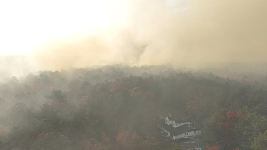 NEW JERSEY, US – NOV 5, 2024: Several homes were evacuated as a wildfire spread through the Colliers Mills Wildfire Management Area in Ocean County, New Jersey. The blaze, which threatens 25 structures, prompted an emergency response to safeguard nearby communities as firefighters worked to contain the flames amid dry, windy conditions. (Photo by Lokman Vural Elibol/Anadolu via Getty Images)