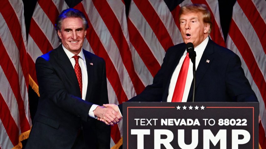 Doug Burgum shakes hands with Donald Trump