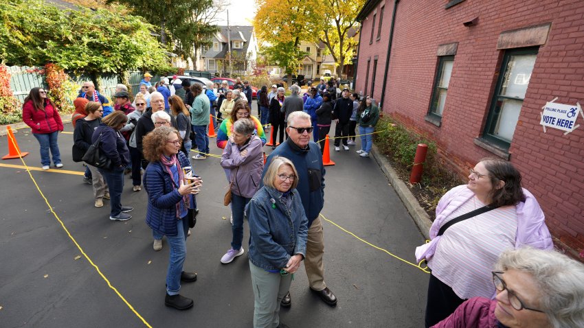 Early voting began in New York state Oct. 26 and people wait in line at the Susan B. Anthony House to cast their ballots.