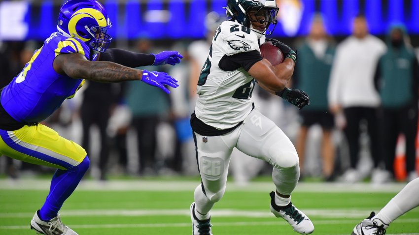 Nov 24, 2024; Inglewood, California, USA; Philadelphia Eagles running back Saquon Barkley (26) runs the ball ahead of Los Angeles Rams safety Quentin Lake (37) during the first half at SoFi Stadium. Mandatory Credit: Gary A. Vasquez-Imagn Images