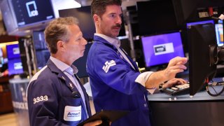 Traders work on the floor of the New York Stock Exchange during morning trading on Nov. 26, 2024.