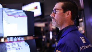 A trader works on the floor of the New York Stock Exchange (NYSE) at the opening bell on November 26, 2024, in New York City. 