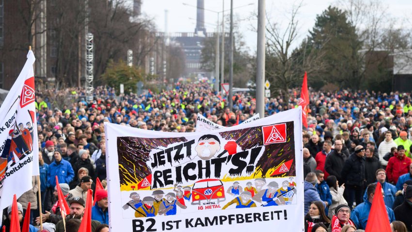 Striking Volkswagen workers gather outside the Volkswagen factory on December 2, 2024 in Emden, Germany.