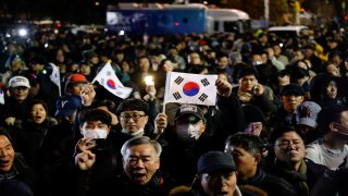 People gather outside the National Assembly, after South Korean President Yoon Suk Yeol declared martial law, in Seoul, South Korea, December 4, 2024. 