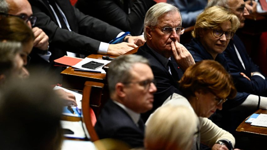 France’s Prime Minister Michel Barnier (C) looks on during a session of questions to the government at The National Assembly in Paris, on December 3, 2024. 