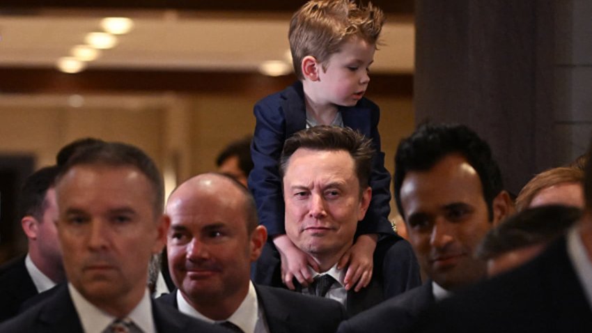 Tesla CEO Elon Musk (C), co-chair of the newly created Department of Government Efficiency (DOGE), carries his son “X” on his shoulders before a meeting with members of Congress at the US Capitol in Washington, DC, on December 5, 2024. 