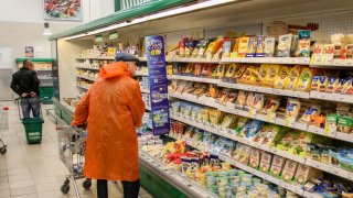 A customer with a cart chooses cheese at the Okey supermarket in St. Petersburg. 