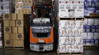 Cases of Jim Beam brand bourbon sit stacked in the warehouse at Southern Glazer’s Wine and Spirits LLC distribution center in Louisville, Kentucky, on Sept. 28, 2018.