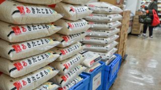 Bags of rice sit stacked high in a supermarket in central Tokyo on November 22, 2024.