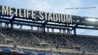 A plan pulls a banner, directed at New York Giants owner John Mara, over Met Life Stadium