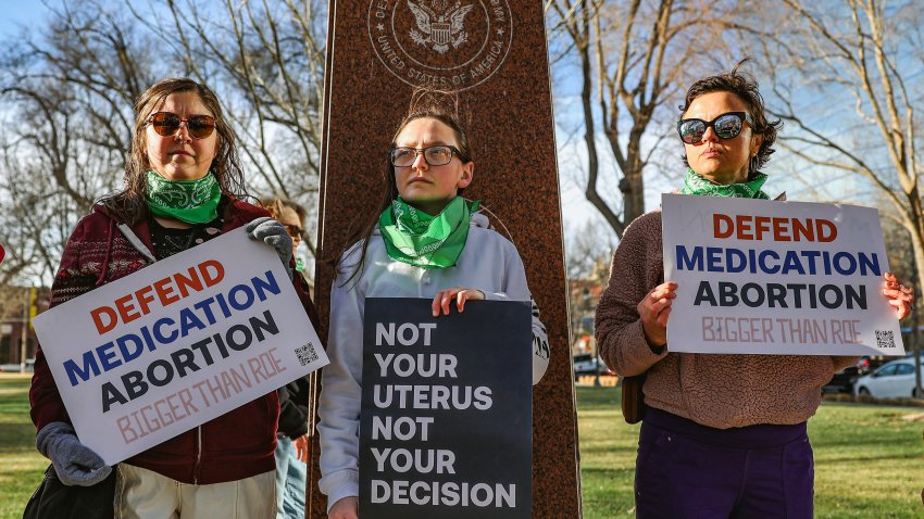 FILE – Three members of the Women’s March group protest in support of access to abortion medication outside the Federal Courthouse on Wednesday, March 15, 2023 in Amarillo, Texas.