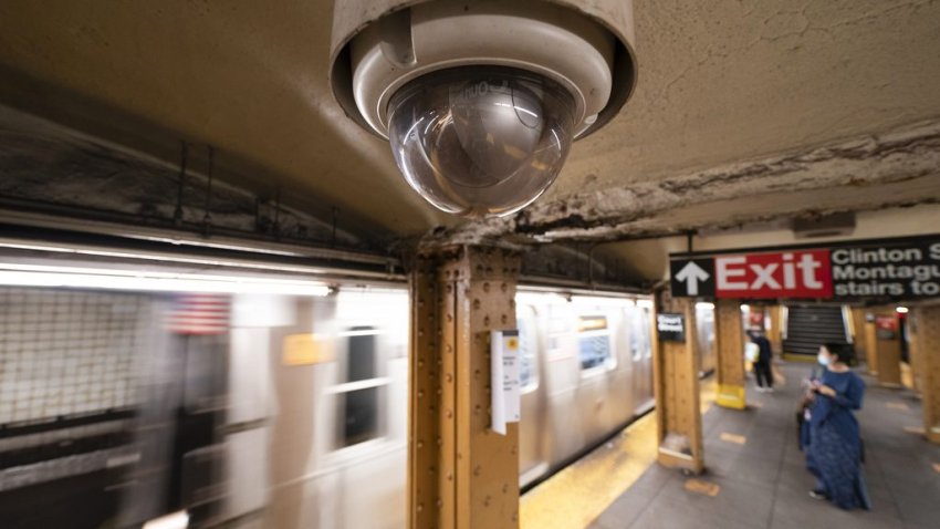 A video surveillance camera hangs from the ceiling above a subway platform, Oct. 7, 2020, in the Brooklyn borough of New York. (AP Photo/Mark Lennihan, File)