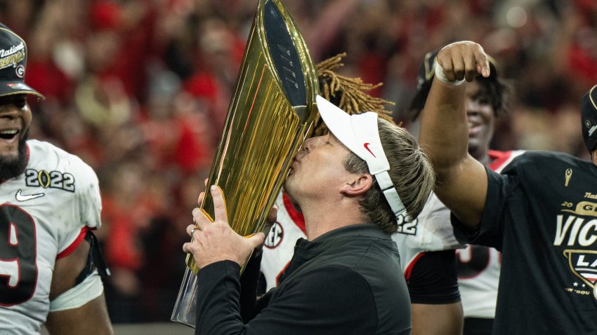 Kirby Smart kisses 2022 CFP national championship trophy