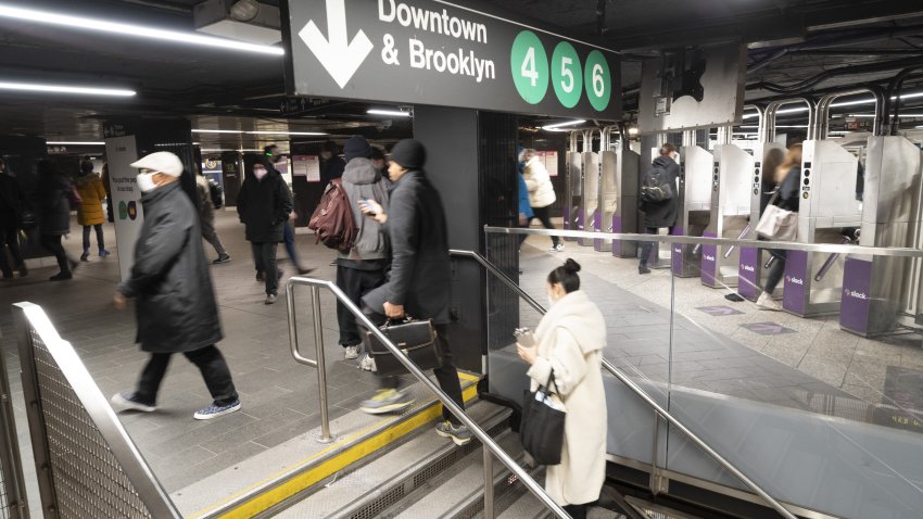 Commuters at the Grand Central subway station in New York, U.S., on Monday, March 28, 2022. The “pizza principle,” a mainstay of New York economics for more than four decades, states that a slice of cheese pizza will always be the same price as a subway ride–but no longer can this theory be found true.