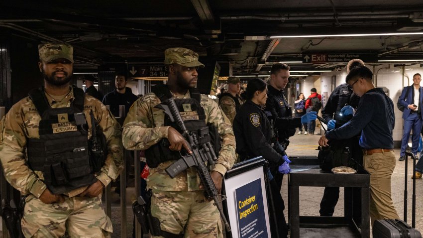 New York State Police officers conduct a container inspection, right, alongside members of the National Guard at the Grand Central-42 Street subway station in New York, US, on Wednesday, March 6, 2024. New York Governor Kathy Hochul is deploying 750 National Guard officers into New York City’s subway system after a rash of violent incidents has reignited fresh concerns about safety on the biggest US transit network. Photographer: Yuki Iwamura/Bloomberg via Getty Images