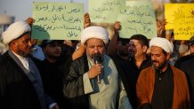 Protesters lift placards expressing support for a proposed amendment to the Iraqi Personal Status Law under discussion at the Parliament, during a rally in Tahrir Square in central Baghdad on September 8, 2024. Rights advocates are alarmed by the bill, which would allow citizens to choose either religious authorities or the civil judiciary to decide on family affairs, saying it would roll back women's rights and increase underage marriage in the deeply patriarchal society. (Photo by AHMAD AL-RUBAYE / AFP) (Photo by AHMAD AL-RUBAYE/AFP via Getty Images)