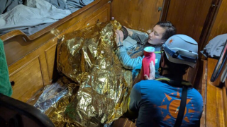 Rescue workers assist a young girl from Sierra Leone after she survived three days afloat in the Mediterranean Sea.