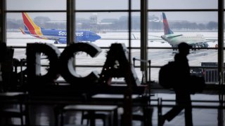 Airplanes on the tarmac during a snow storm at Ronald Reagan Washington National Airport in Arlington, Virginia, US, on Monday, Jan. 6, 2025. 