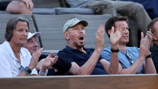 Oracle co-founder Larry Ellison, center, watches Andy Murray of Great Britain against Alexander Zverev of Germany during their third round match on Day 9 of the BNP Paribas Open at the Indian Wells Tennis Garden on October 12, 2021 in Indian Wells, California.