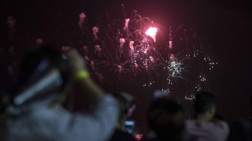 People watch a New Year's fireworks