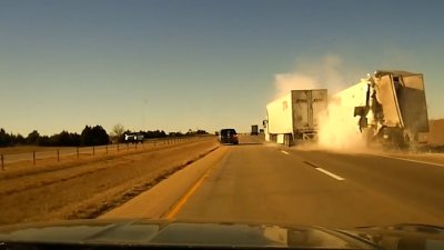 WATCH: Close call crash when truck driver reaches down to grab a water bottle