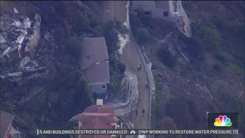 Pacific Palisades home left standing by wildfire breaks apart in landslide