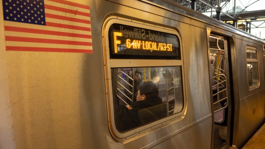 FILE – Commuters sit on the F train at the Coney Island-Stillwell Avenue Station, Thursday, Dec. 26, 2024, in New York.