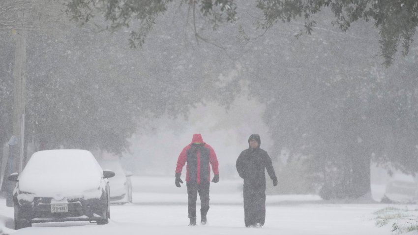 People take a walk in the neighborhood Tuesday, Jan. 21, 2025, in Houston.