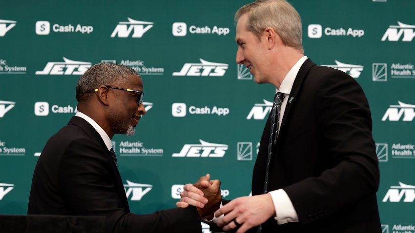 New York Jets new head coach Aaron Glenn, left, shakes hands with general manager Darren Mougey during a press conference at the NFL football team’s training facility on Monday, Jan. 27, 2025, in Florham Park, N.J.