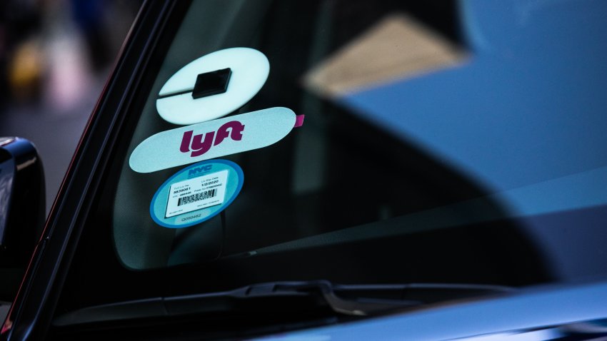 Uber Technologies Inc. and Lyft Inc. stickers are displayed on a vehicle in the Time Square neighborhood of New York, U.S., on Wednesday, May 8, 2019. Simmering tensions between drivers and ride-hailing companies are flaring again, as drivers in major cities across the U.S. and the U.K. went on strike Wednesday over low wages and unstable working conditions. Photographer: Jeenah Moon/Bloomberg via Getty Images